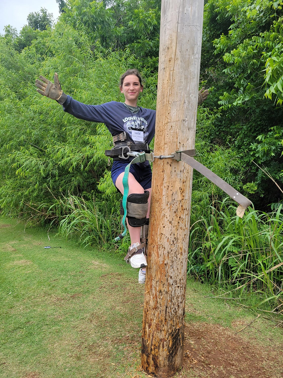 Energy Camp participant Rachel Hembree climbing an electric pole.