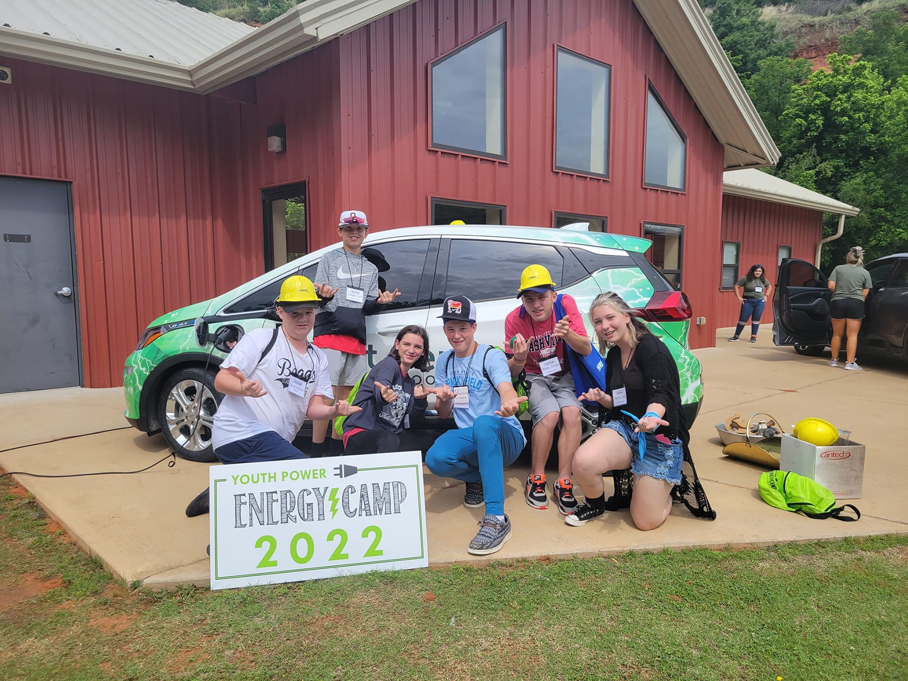 Energy Camp 2022 Participants on the last day of camp, posing with East Central Electric Cooperative's electric vehicle. 
