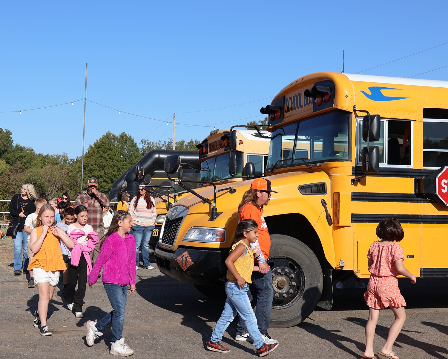 Kids getting off the school buses. 